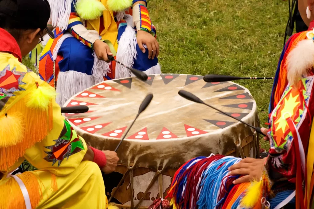 A group of Native Americans, adorned in colorful traditional attire, captured everyone’s attention as they rhythmically played a drum.