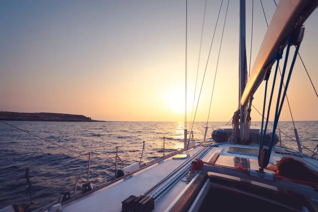 A sailboat in the mild sunset light.