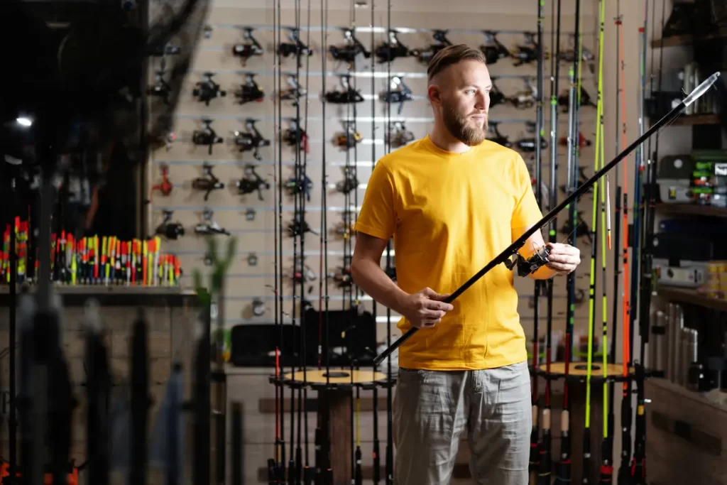 A man in a fishing tackle store looking forward to his time on the water.