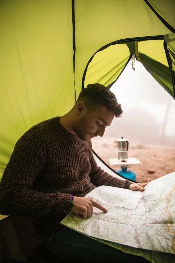 A man at Basecamp in his tent preparing for his next climb.